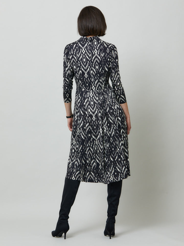 Sonia, a feminine take on the shirt dress. crafted in a fluid black and cream ikat printed viscose. A softly pleated skirt that falls to mid-calf. Wear to work, to the theatre, or out for cocktails with the girls. A simple yet feminine silhouette.