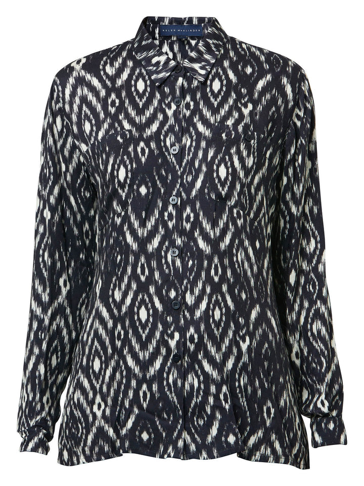 Ella, a classic utilitarian shirt crafted in a fluid black and cream ikat printed viscose. This must-have shirt features patch pockets, back yoke & center back box pleat. an easy-fit shirt to elevate your everyday. Helen's tip - style with the jill black pant for a sense of put-together ease.