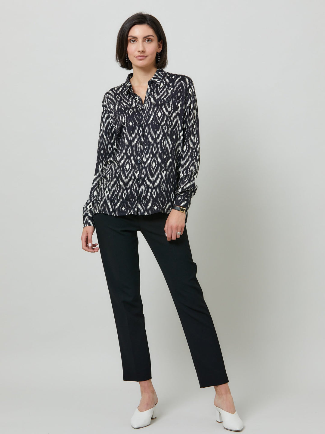 Ella, a classic utilitarian shirt crafted in a fluid black and cream ikat printed viscose. This must-have shirt features patch pockets, back yoke & center back box pleat. an easy-fit shirt to elevate your everyday. Helen's tip - style with the jill black pant for a sense of put-together ease.