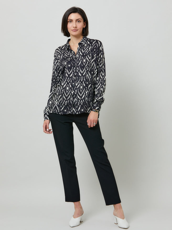 Ella, a classic utilitarian shirt crafted in a fluid black and cream ikat printed viscose. This must-have shirt features patch pockets, back yoke & center back box pleat. an easy-fit shirt to elevate your everyday. Helen's tip - style with the jill black pant for a sense of put-together ease.