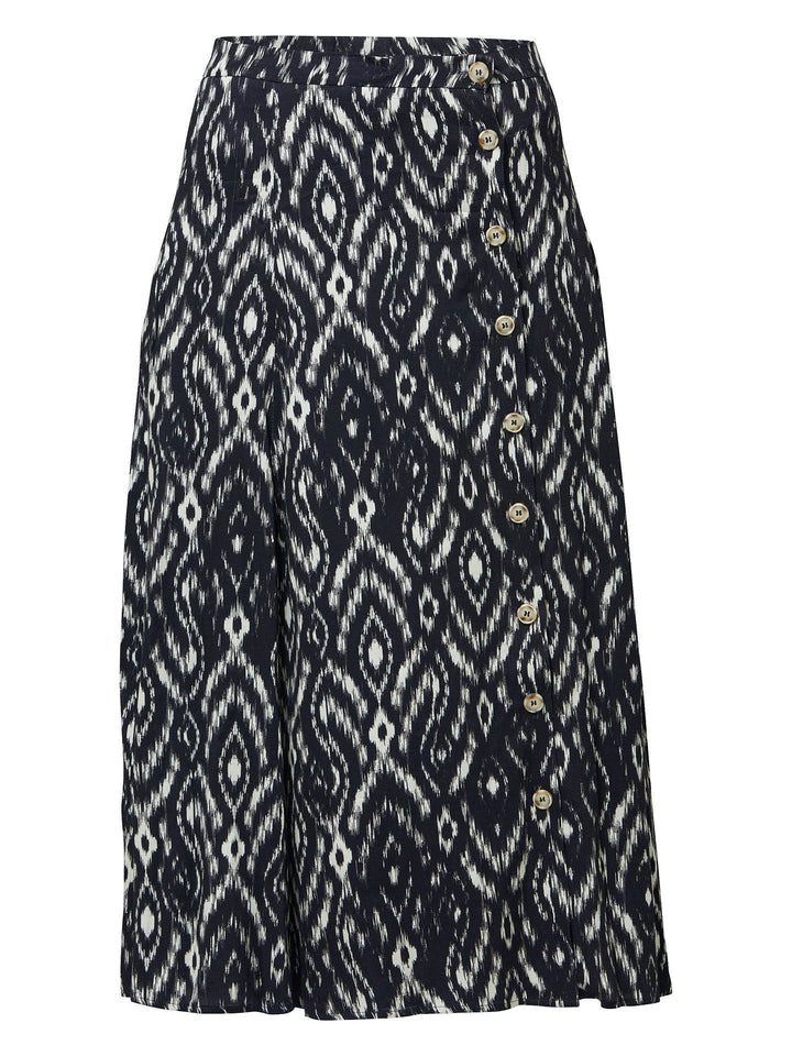 Meet saddie, the essential transeasonal skirt. Crafted in a fluid black and cream ikat printed viscose.. Off centered button through a-line silhouette with an elasticated back waist band. Relaxed elegance for everyday life. Style with our black timeless tops or dress it down with the khloe oatmeal sweatshirt.
