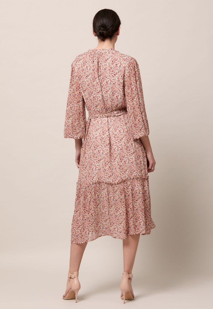 Bailey, femininity is having a moment. This flattering fit and flare silhouette offers a v-neckline with a frill embellished bodice. Waist is accentuated with a soft belt around the midriff for a customisable look that cinches the profile. The belt can be tied in the front or the back, adding versatility to this style. The voluminous semi-sheer sleeves subtly balance the classic design, finished with an elasticated cuff.