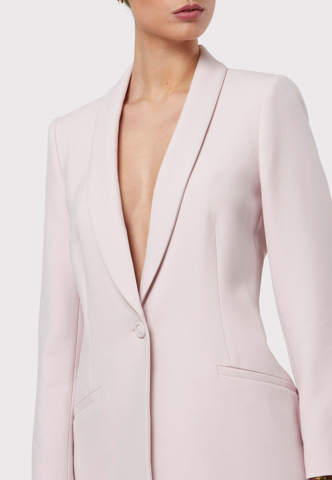 Meet the Darcie Soft Pink Jacket, a chic choice for minimalists. This tuxedo-style jacket boasts a seamless shawl collar, sleek welt pockets, and a flattering semi-fitted silhouette with a single-button closure. Crafted from our signature fabric blend, it offers comfort with a hint of stretch. Pair it with the matching Naomi Soft Pink Tailored Trouser for a complete, polished look.