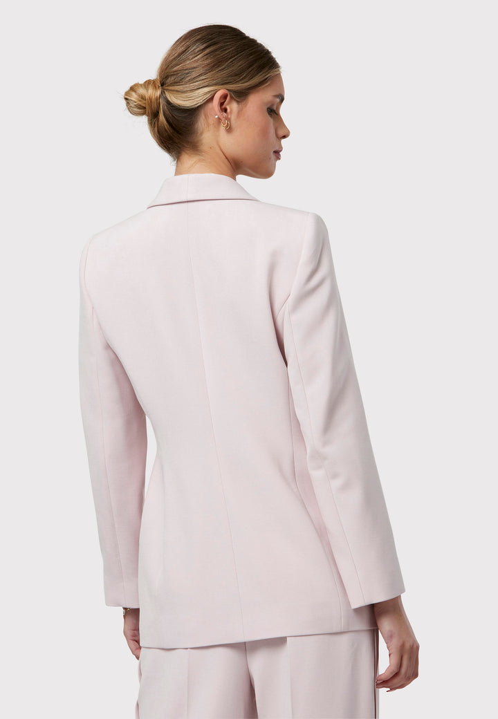 Meet the Darcie Soft Pink Jacket, a chic choice for minimalists. This tuxedo-style jacket boasts a seamless shawl collar, sleek welt pockets, and a flattering semi-fitted silhouette with a single-button closure. Crafted from our signature fabric blend, it offers comfort with a hint of stretch. Pair it with the matching Naomi Soft Pink Tailored Trouser for a complete, polished look.