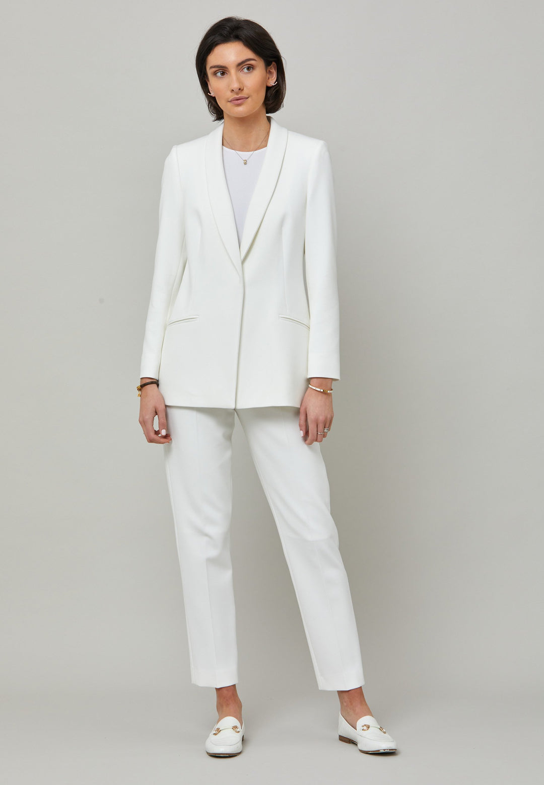 Darcie, a minimalist wardrobe must-have. This investment-worthy tailored tux jacket is engineered with a classic shawl collar and simple jeet pockets. Cut to a semi fitted silhouette with a single button closure. Fabricated in our signature double crepe with a hint of stretch in iconic white. The perfect balance between classic & elegance. Pair with a simple tee or elevate the look with the co-ordinating jill pant.