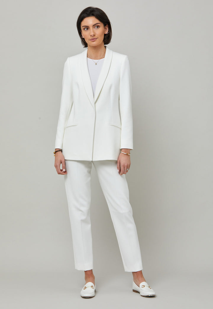 Darcie, a minimalist wardrobe must-have. This investment-worthy tailored tux jacket is engineered with a classic shawl collar and simple jeet pockets. Cut to a semi fitted silhouette with a single button closure. Fabricated in our signature double crepe with a hint of stretch in iconic white. The perfect balance between classic & elegance. Pair with a simple tee or elevate the look with the co-ordinating jill pant.