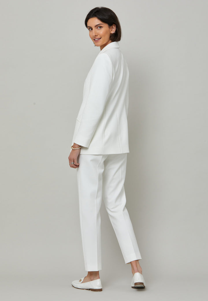 Darcie, a minimalist wardrobe must-have. This investment-worthy tailored tux jacket is engineered with a classic shawl collar and simple jeet pockets. Cut to a semi fitted silhouette with a single button closure. Fabricated in our signature double crepe with a hint of stretch in iconic white. The perfect balance between classic & elegance. Pair with a simple tee or elevate the look with the co-ordinating jill pant.