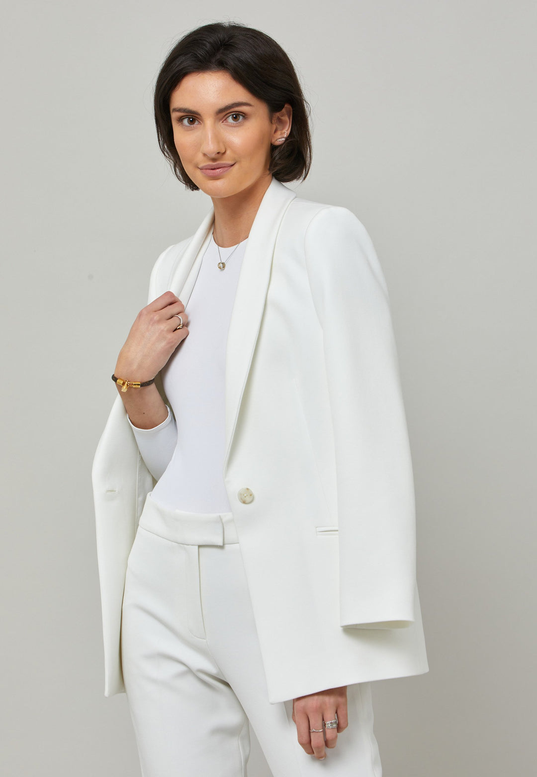 Darcie, a minimalist wardrobe must-have. This investment-worthy tailored tux jacket is engineered with a classic shawl collar and simple jeet pockets. Cut to a semi fitted silhouette with a single button closure. Fabricated in our signature double crepe with a hint of stretch in iconic white. The perfect balance between classic & elegance. Pair with a simple tee or elevate the look with the co-ordinating jill pant.