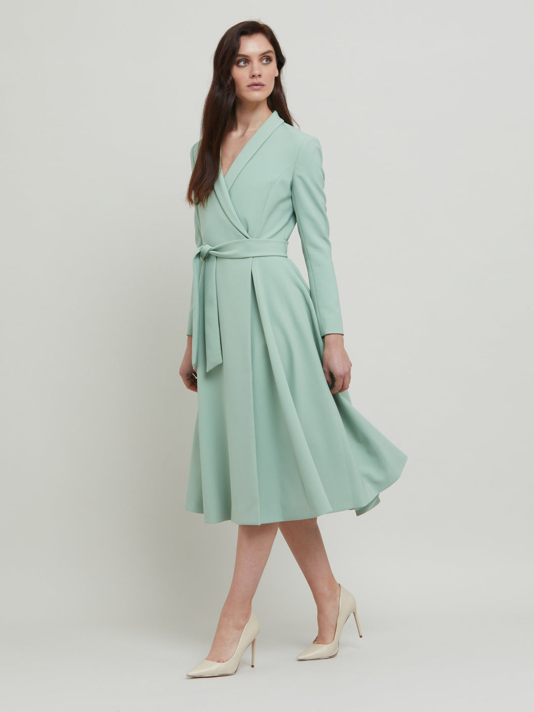 Dawn, the ultimate coat dress. Neat shawl collar, flattering fit & flare shape with handy pockets and an elegant full skirt that falls below the knee. Crafted in our signature double crepe with a hint of stretch in willow green. Attending a summer wedding? Mother of the bride? Heading to the races? This is the dress for you.