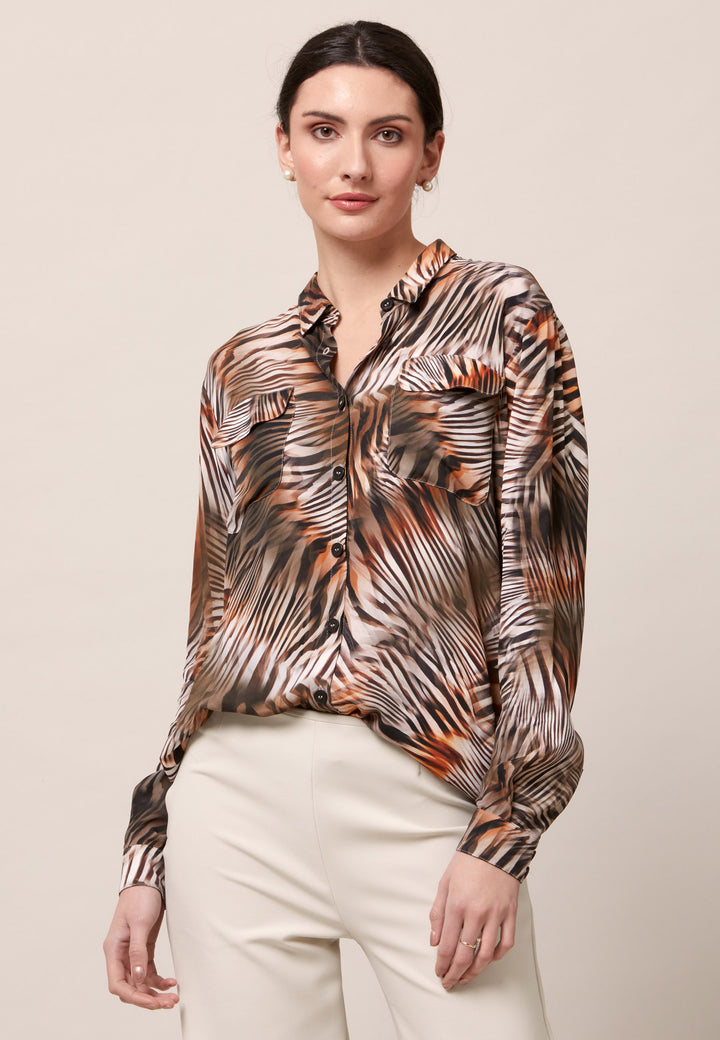 Elevate your day edit with the Ella utility shirt. It's engineered from a semi-sheer printed viscose crepe. This must-have shirt features patch pockets, back yoke & center back box pleat. An easy-fit shirt to elevate your everyday. Tuck into the Jill trousers then add heels and a blazer to create a refined daytime look that easily transitions into evening plans.