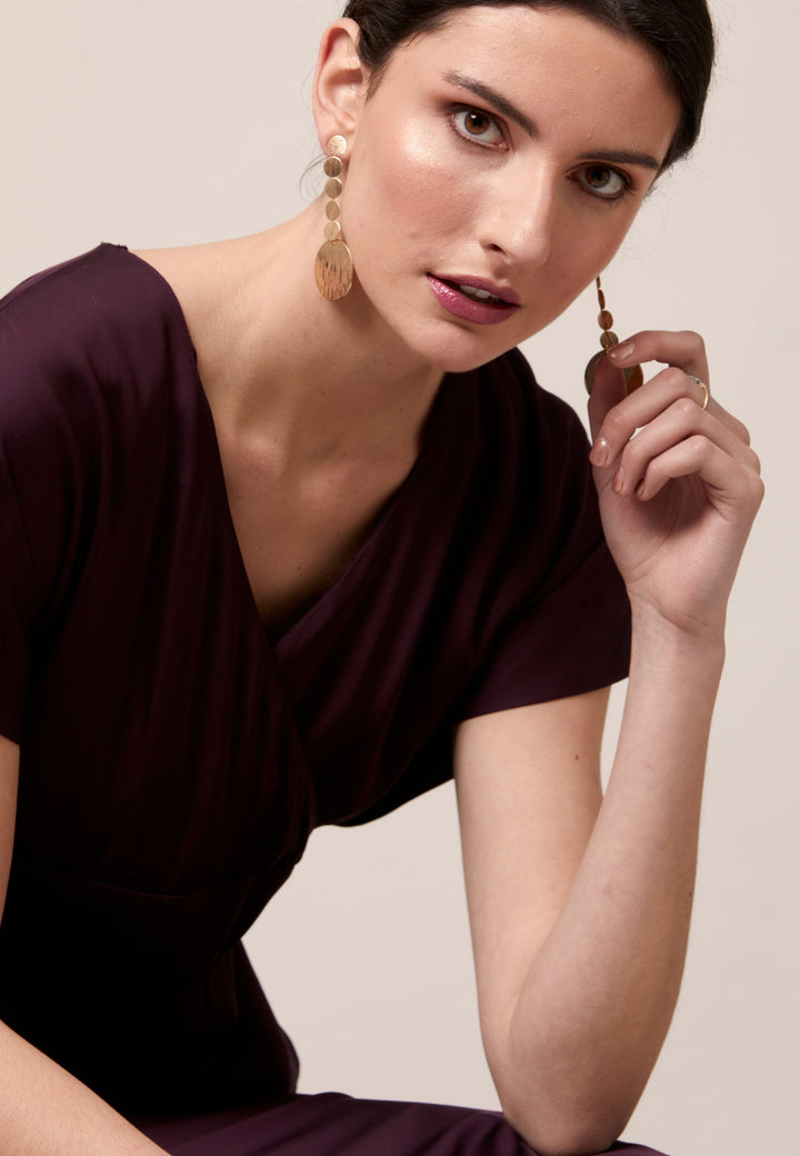 Evening edits get upgraded with the Fleur dress. Crafted in a luxurious Aubergine satin viscose. An easy-fitting silhouette with a v-neckline. Skirt falls to the mid-calf and side seam slit adds a sense of allure. Features handy Side seam pockets. Engineered with an elegant key-hole back neck detail. Simply add heels and a clutch for a look that turns heads at any event. Classic Occasionwear, modernized.