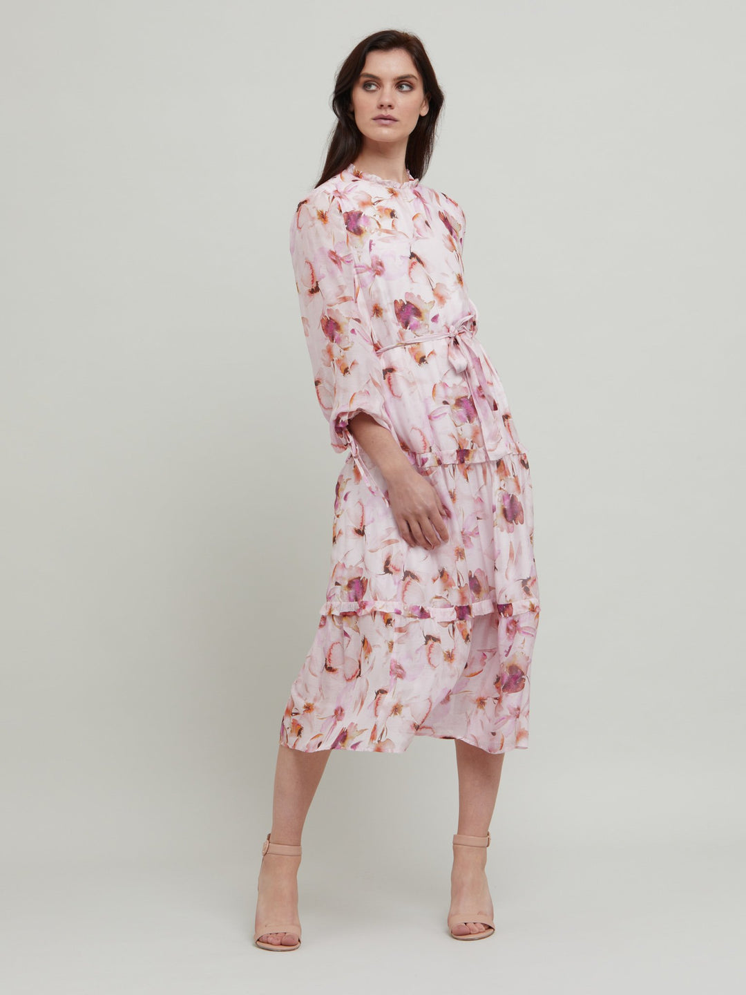 Meet Flo, a super feminine silhouette with pleated jewel neckline, keyhole back, full sleeves that fall to an elasticated cuff with tie detail. Tiered skirt falls to below the knee. The dress can be worn with or without the belt. Crafted in our super soft silk in a delicate watercolour floral print. Perfect for summer weddings, garden parties or wherever you'd like to make an entrance.