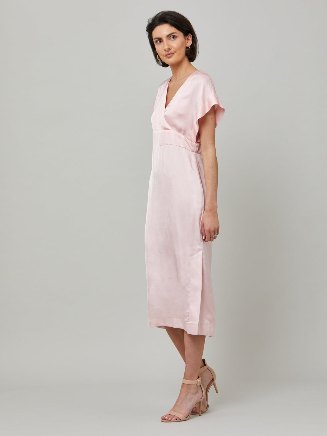 Classic occasion wear, modernized. Meet the Fleur dress in luxurious blossom pink satin viscose. An easy-fitting silhouette with a V-neckline, falls to the mid-calf and features side slit, pockets, and an elegant key-hole back neck detail. Attending a summer wedding? Mother of the bride? Heading to the races? This is the dress for you.