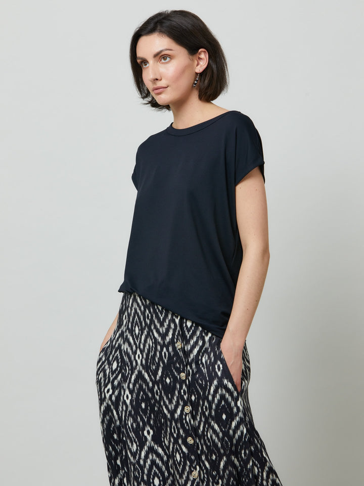 Gina, a fluid T-shirt with a clean crew neck, made to be worn oversized for slouchy ease. Fabricated in fine knit, this style features our elevated neutrals collection. Styled with the fun & elegant Riley Skirt.