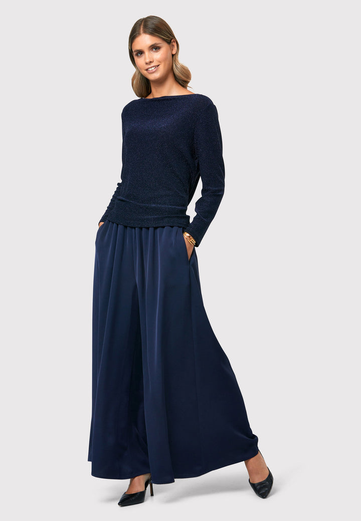 Imogen Midnight Navy Trousers, a chic and versatile addition to your wardrobe. Crafted with a wide leg and made from machine washable satin-back crepe fabric, these trousers offer comfort with an elasticated gathered waistband.