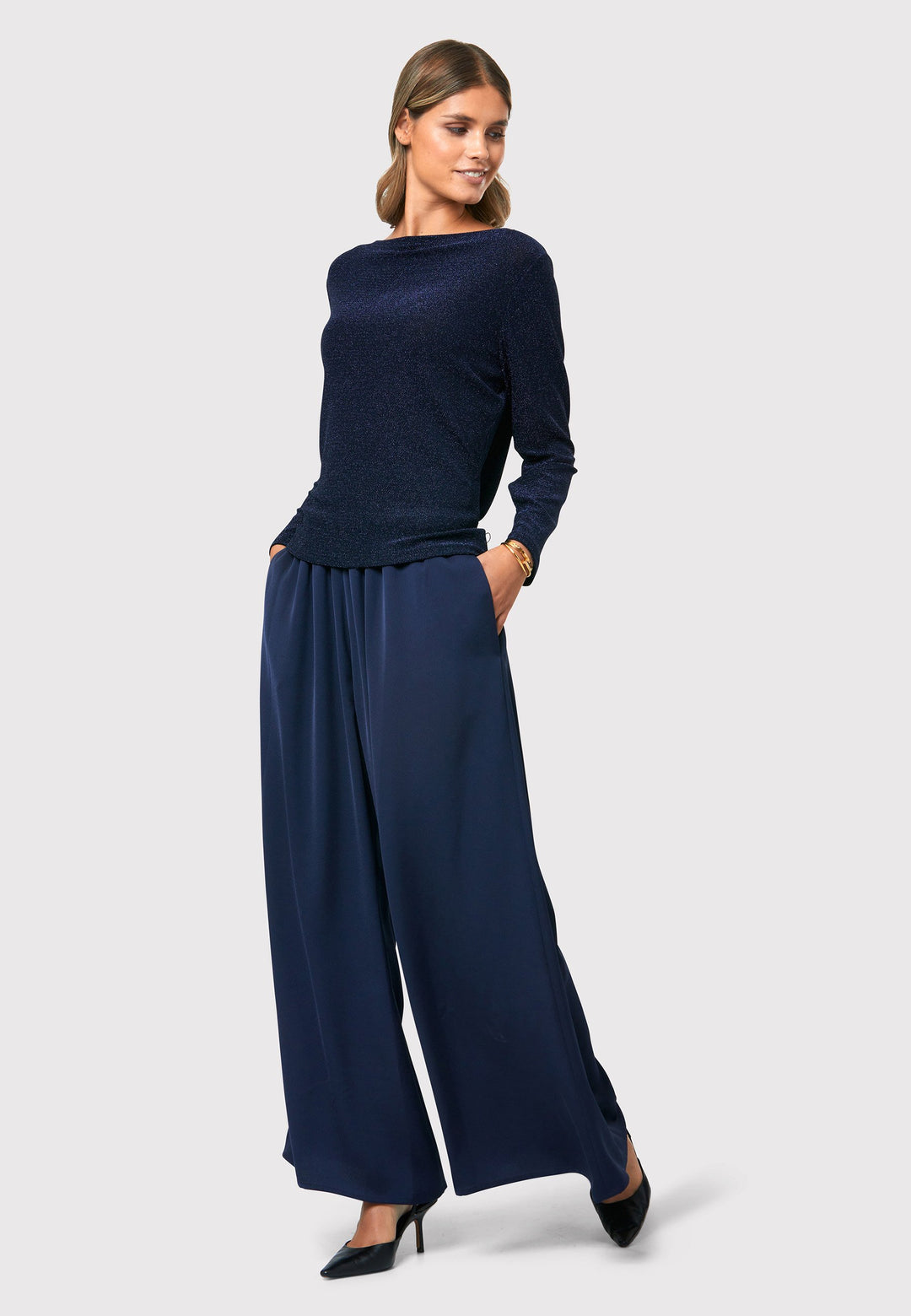 Imogen Midnight Navy Trousers, a chic and versatile addition to your wardrobe. Crafted with a wide leg and made from machine washable satin-back crepe fabric, these trousers offer comfort with an elasticated gathered waistband.