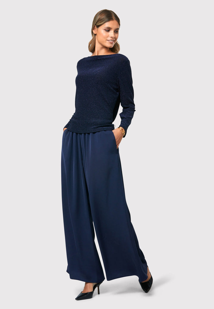 Imogen Midnight Navy Trousers, a chic and versatile addition to your wardrobe. Crafted with a wide leg and made from machine washable satin-back crepe fabric, these trousers offer comfort with an elasticated gathered waistband.