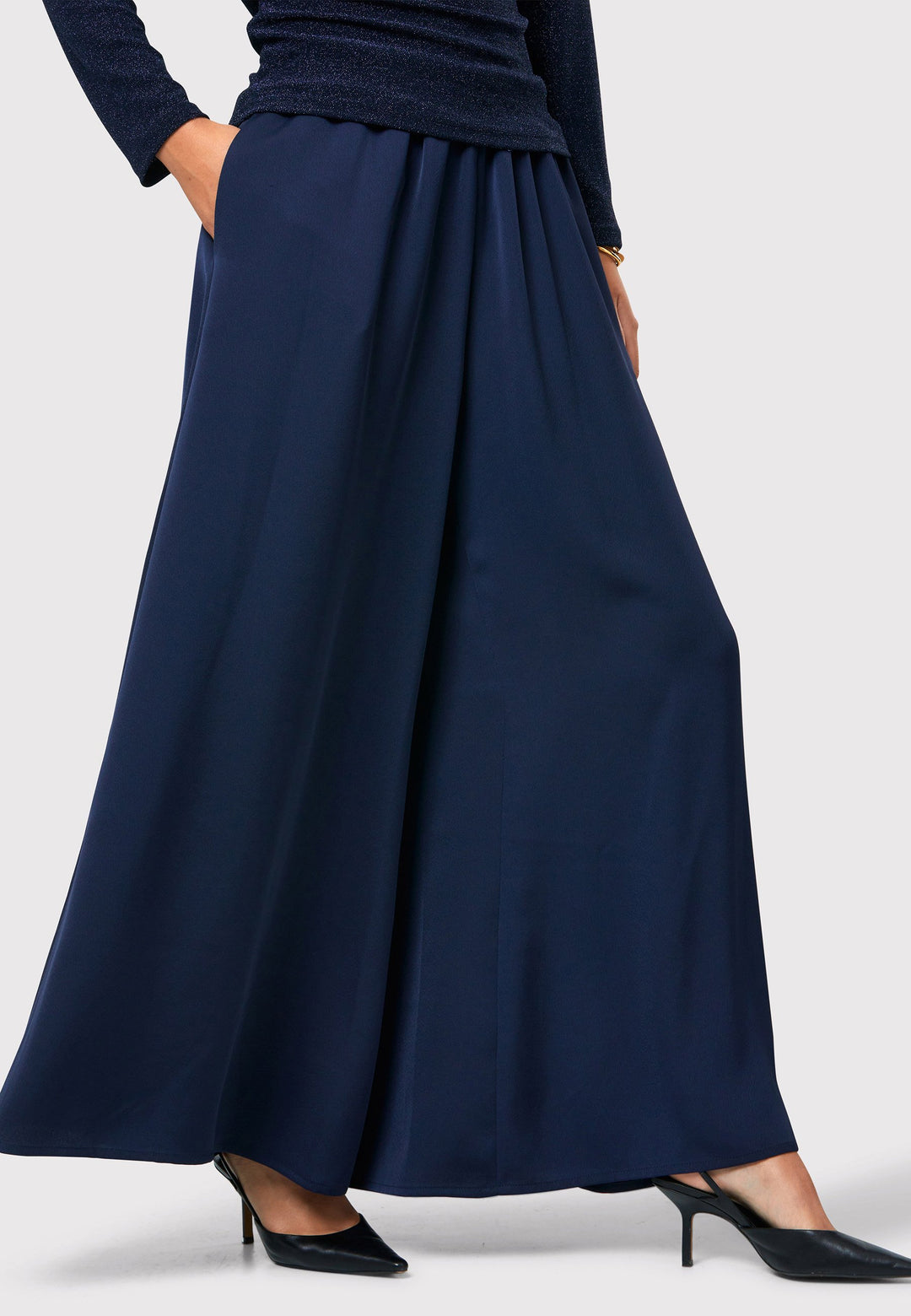 Imogen Midnight Navy Trousers, a chic and versatile addition to your wardrobe. Crafted with a wide leg and made from machine washable satin-back crepe fabric, these trousers offer comfort with an elasticated gathered waistband.
