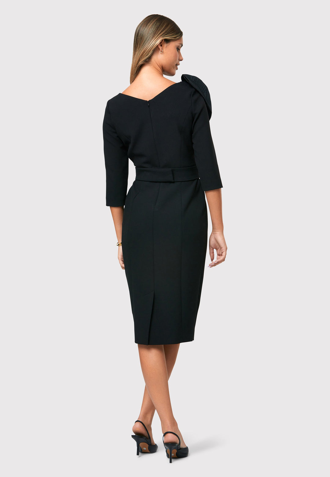 Introducing the Isadora Black Dress, a modern take on a classic Helen McAlinden design. With its exquisite craftsmanship and flattering silhouette, it accentuates your figure while offering practicality with pockets, a detachable belt, and a pencil skirt that elegantly falls to a mid-calf length. Adding to its versatility, the Isadora Black Dress features a detachable moire design bow that can be styled in multiple ways.