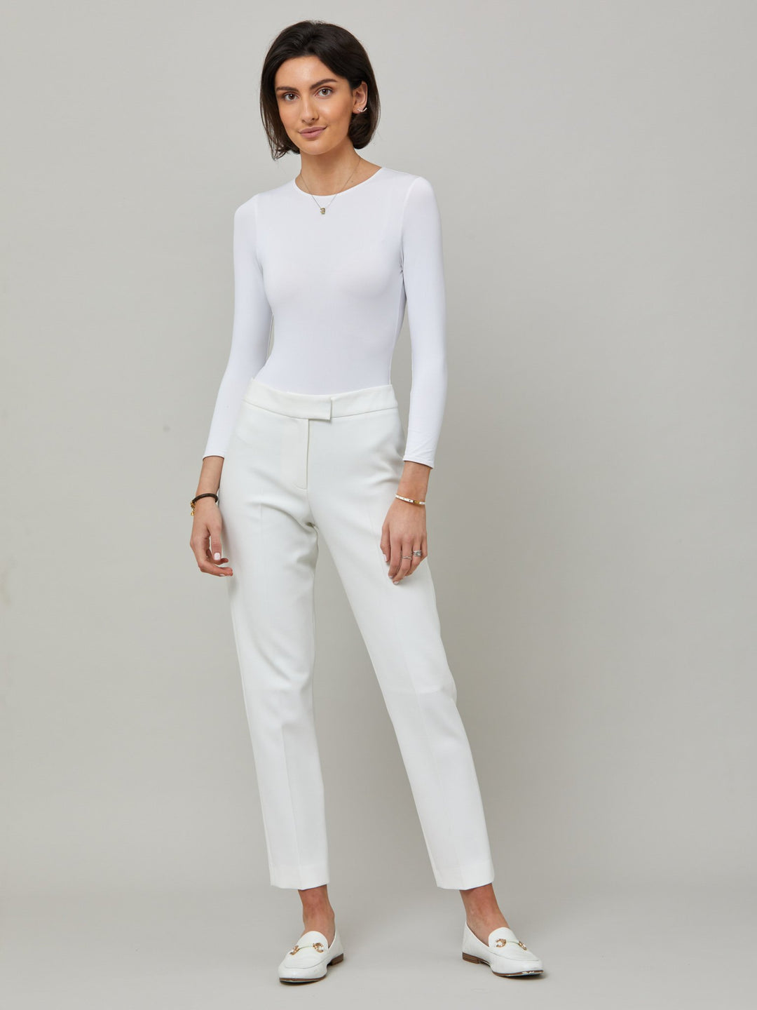 model wearing jill white pant  Investment-worthy, neat narrow-leg trouser with a hint of stretch. A wardrobe staple and HMcA classic, here in optical white.