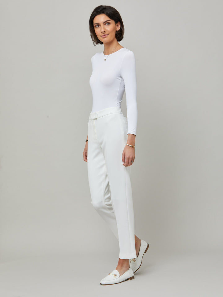side picture of model wearing  Investment-worthy, neat narrow-leg trouser with a hint of stretch. A wardrobe staple and HMcA classic, here in optical white.