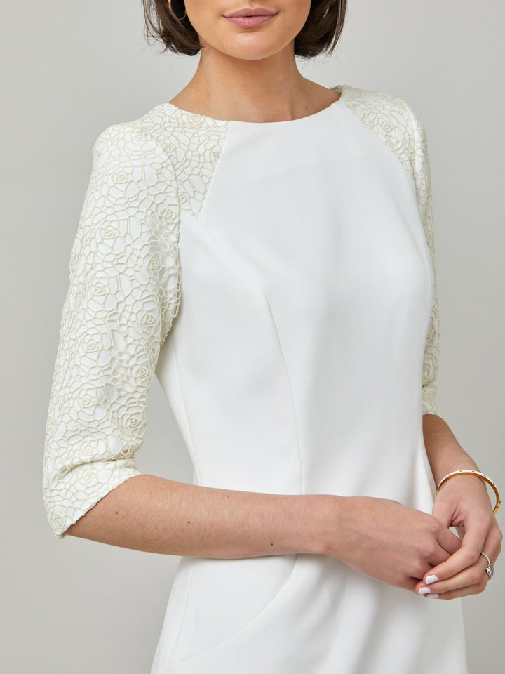 sleeve detail of Juliet, A form-flattering, body-skimming silhouette in iconic white. Features a 3/4 sleeve with lace overlay. The skirt falls to a demure finish below the knee. Attending a summer wedding? Mother of the bride? Heading to the races? This is the dress for you.