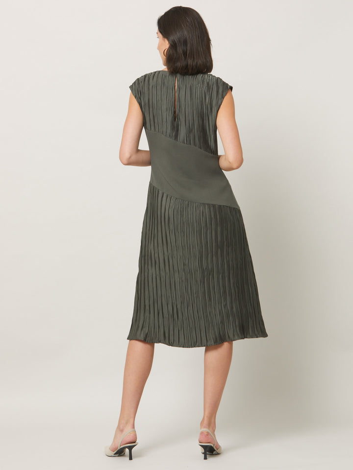 Opt for june, elegant dressing redefined. A simple slip on dress in an olive polished pleated fabric. Cut to a fluid easy fitting silhouette for a timeless mood with a modern look.