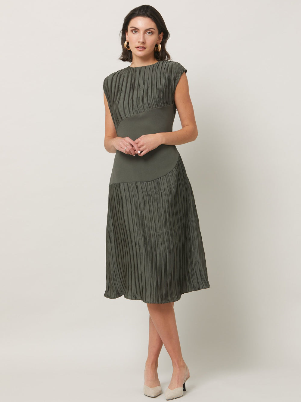 Opt for june, elegant dressing redefined. A simple slip on dress in an olive polished pleated fabric. Cut to a fluid easy fitting silhouette for a timeless mood with a modern look.