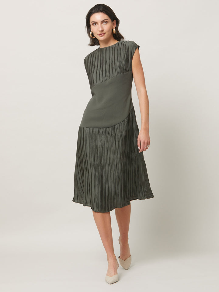 Opt for june, elegant dressing redefined. A simple slip on dress in an olive polished pleated fabric. Cut to a fluid easy fitting silhouette for a timeless mood with a modern look.