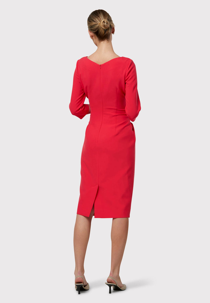 Transition seamlessly from desk to dinner in the Karen Begonia Orange Dress. This figure-flattering silhouette boasts an attached belt that gathers at the side seams to accentuate the waist. Its pencil skirt falls to a chic mid-calf length, enhanced by a refined slash neck for added sophistication. Complete with practical pockets and crafted from sustainably sourced fibers with a touch of stretch, this dress ensures both style and comfort.
