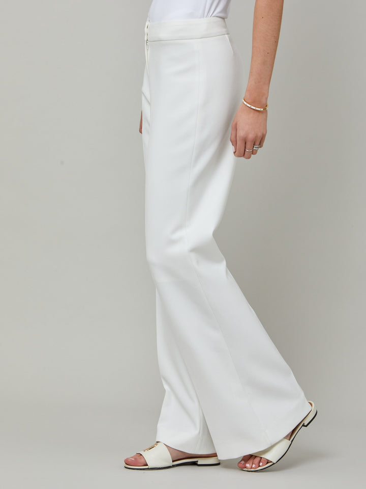 side picture of Kelly, an iconic white flare pant. Crafted in sustainable double crepe with a hint of stretch. Revisit the 70's for this season’s game-changing look. Flares are sophisticated, comfortable & leg-lengthening. Guaranteed to flatter the form & never far from fashion’s front line.