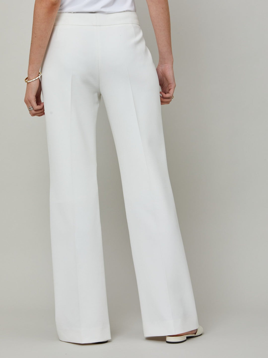 back picture Kelly, an iconic white flare pant. Crafted in sustainable double crepe with a hint of stretch. Revisit the 70's for this season’s game-changing look. Flares are sophisticated, comfortable & leg-lengthening. Guaranteed to flatter the form & never far from fashion’s front line.