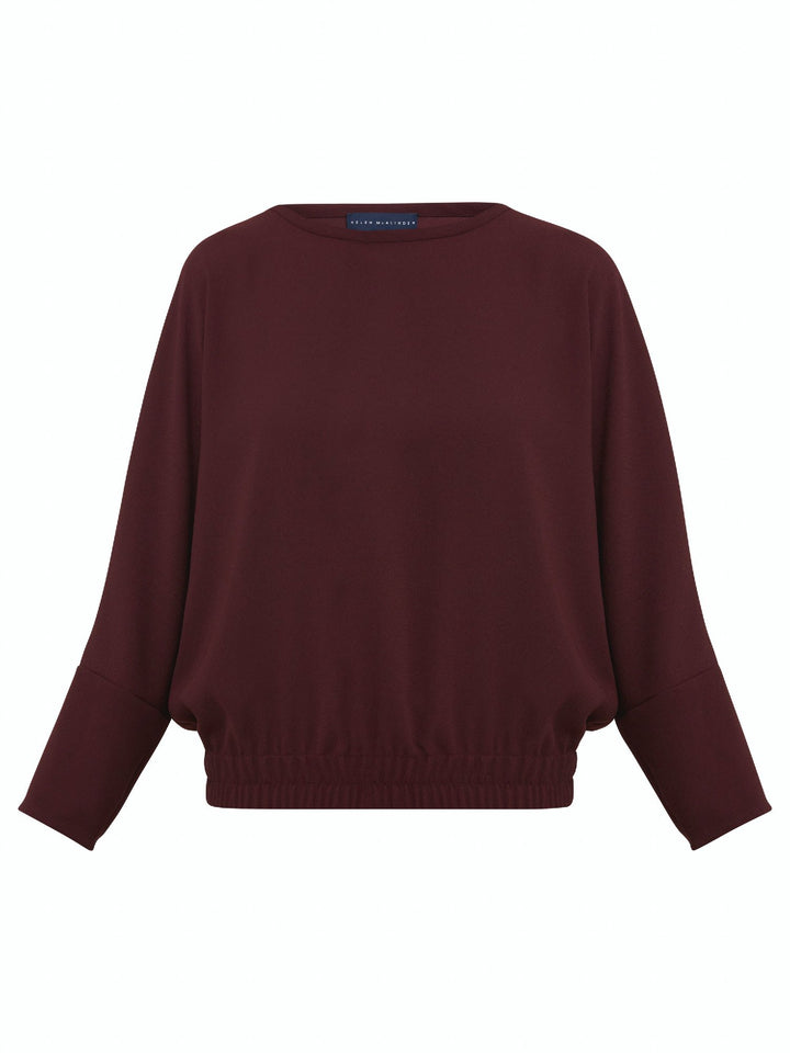 Lal, a crewneck relaxed fit sweatshirt. Crafted in a satin back crepe in rich burgundy. A sporty silhouette featuring an elasticated ribbed hem, dropped shoulder & full-length sleeve. Teams perfectly with matching Charlize pants. Clothes for how we live today! Loungewear re-defined. 