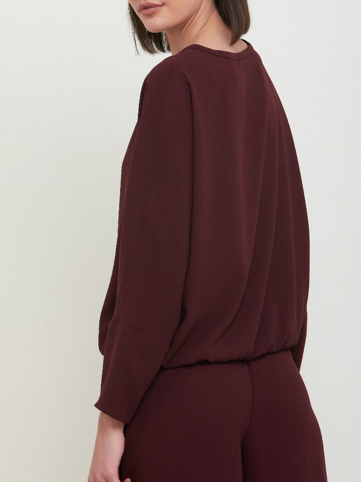 Lal, a crewneck relaxed fit sweatshirt. Crafted in a satin back crepe in rich burgundy. A sporty silhouette featuring an elasticated ribbed hem, dropped shoulder & full-length sleeve. Teams perfectly with matching Charlize pants. Clothes for how we live today! Loungewear re-defined. 