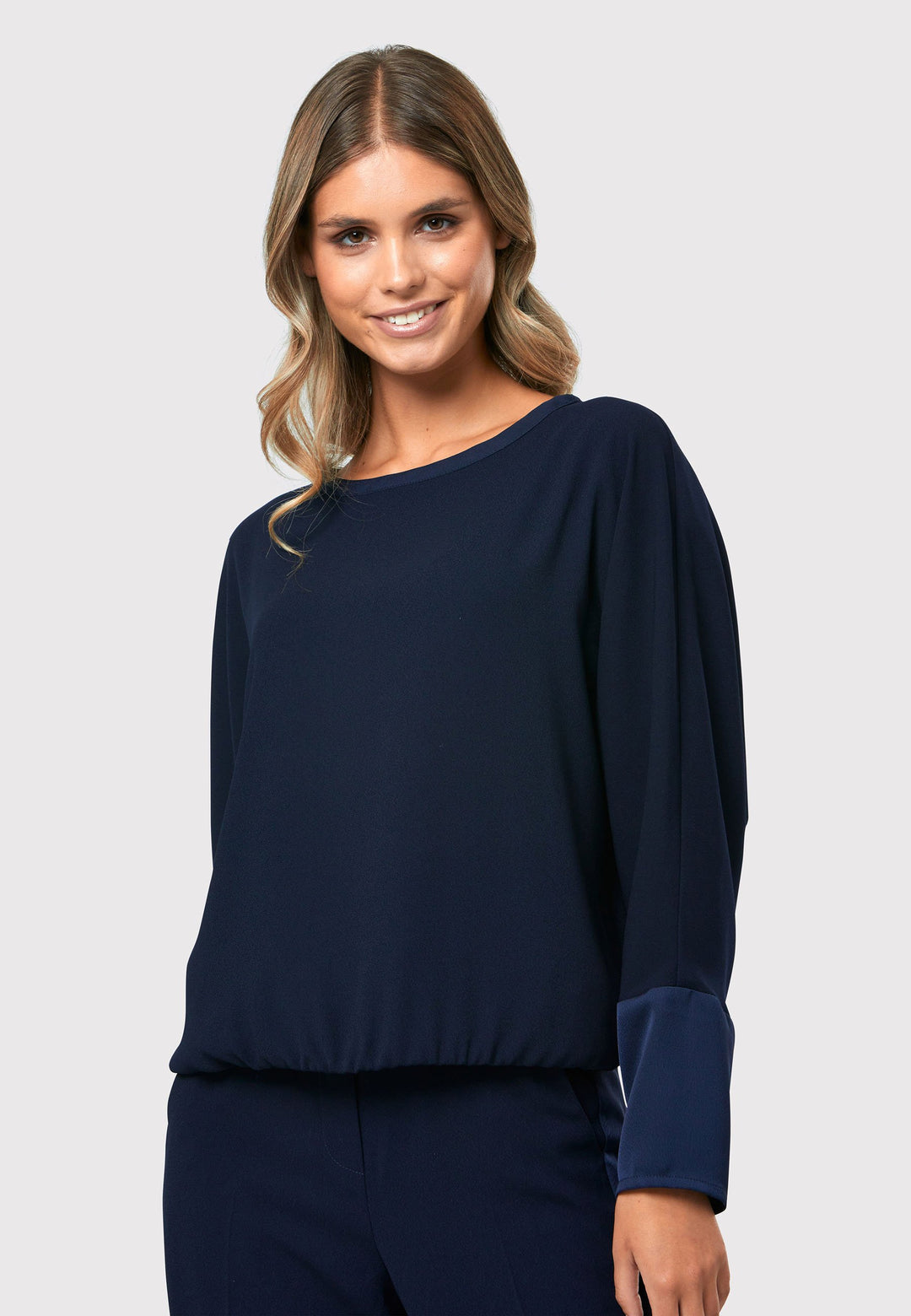al Midnight Navy Top, a stylish and versatile addition to your wardrobe. Crafted from satin back crepe, it offers a luxurious feel and drapes beautifully. The dropped shoulder design, eleasticated hem and full-length sleeves 