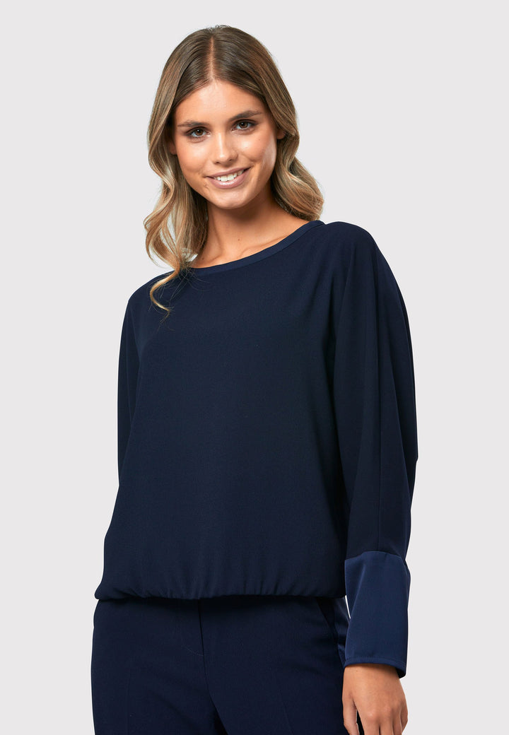 al Midnight Navy Top, a stylish and versatile addition to your wardrobe. Crafted from satin back crepe, it offers a luxurious feel and drapes beautifully. The dropped shoulder design, eleasticated hem and full-length sleeves 