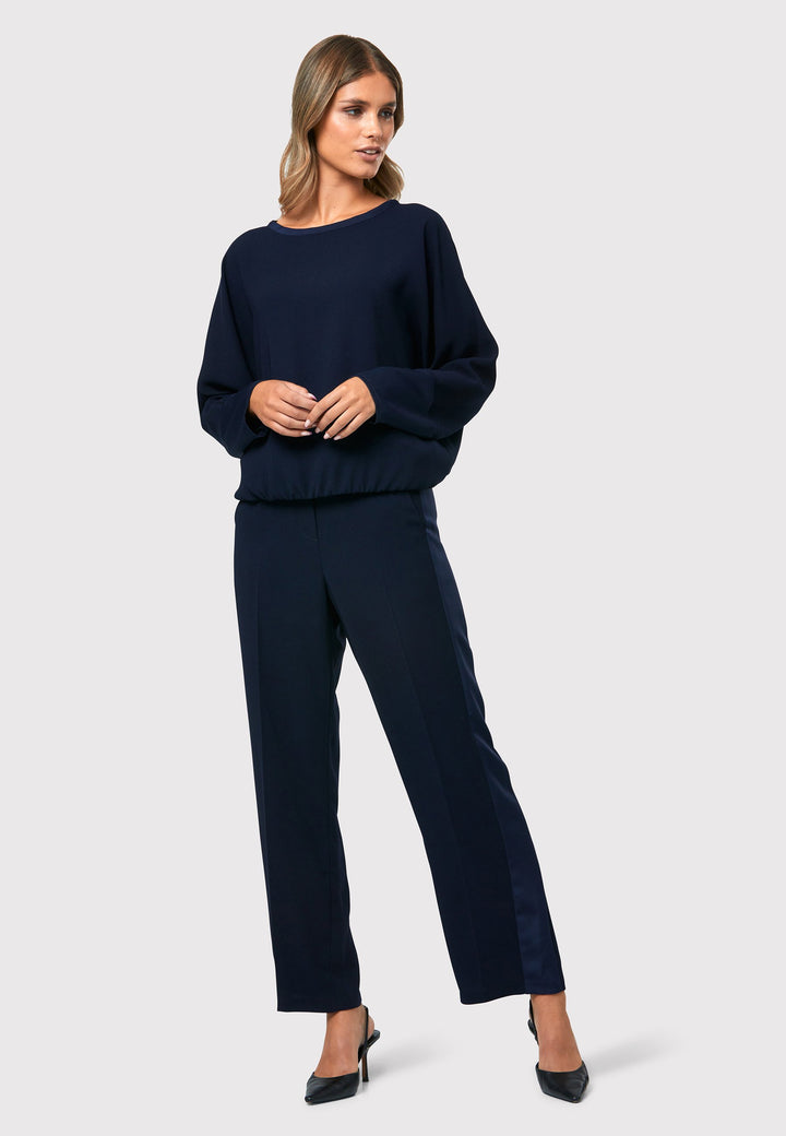 al Midnight Navy Top, a stylish and versatile addition to your wardrobe. Crafted from satin back crepe, it offers a luxurious feel and drapes beautifully. The dropped shoulder design, eleasticated hem and full-length sleeves 