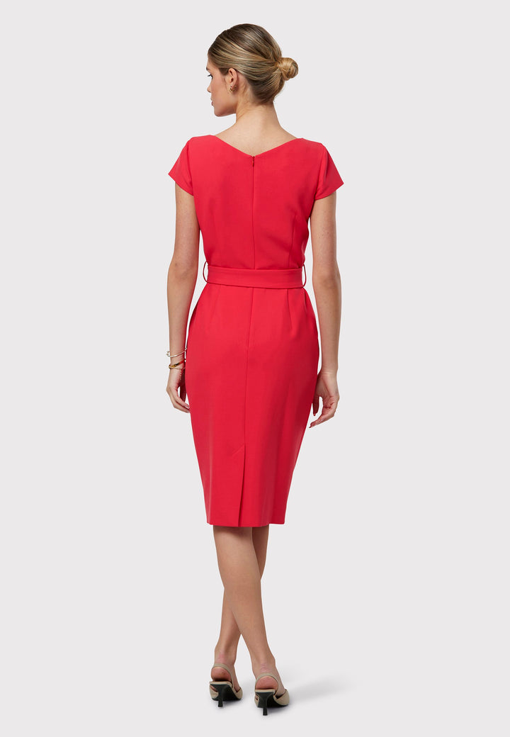 Layla, a capped-sleeve dress featuring a chic slash neck and pencil skirt silhouette. Designed with front tucks and side seam pockets for functionality, it comes with a detachable belt for versatile styling. Crafted from our signature tricotine with a touch of elastane, ensuring both comfort and effortless movement. Shown here in a striking begonia hue.