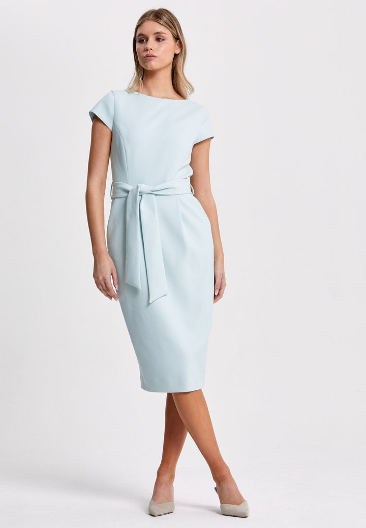 Layla, a capped sleeve, slash neck, pencil skirt silhouette with front tucks, side seam pockets, and a detachable belt. Crafted from sustainably sourced fibers with a hint of elastane to ensure comfort ease of movement.