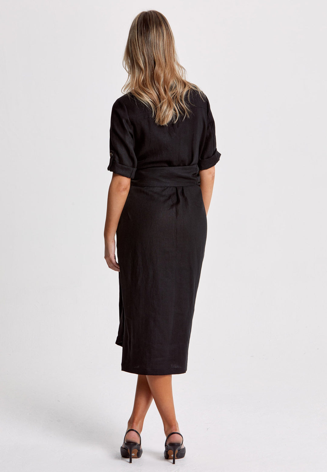 Leonne, the investment-worthy black linen wrap dress. Crafted in a sustainable Irish linen. An authentic wrap dress that ties to the side with a generous belt and flattering gathers at the waist. Engineered with a turned back elbow length sleeve. The ultimate summer staple.