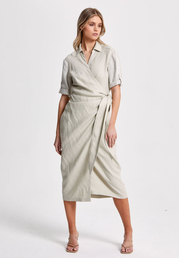 Leonne, the investment-worthy oatmeal linen wrap dress. Crafted in a sustainable Irish linen. An aunthetic wrap dress that ties to the side with a generous belt and flattering gathers at the waist. Engineered with a turned back elbow length sleeve. The ultimate summer staple.