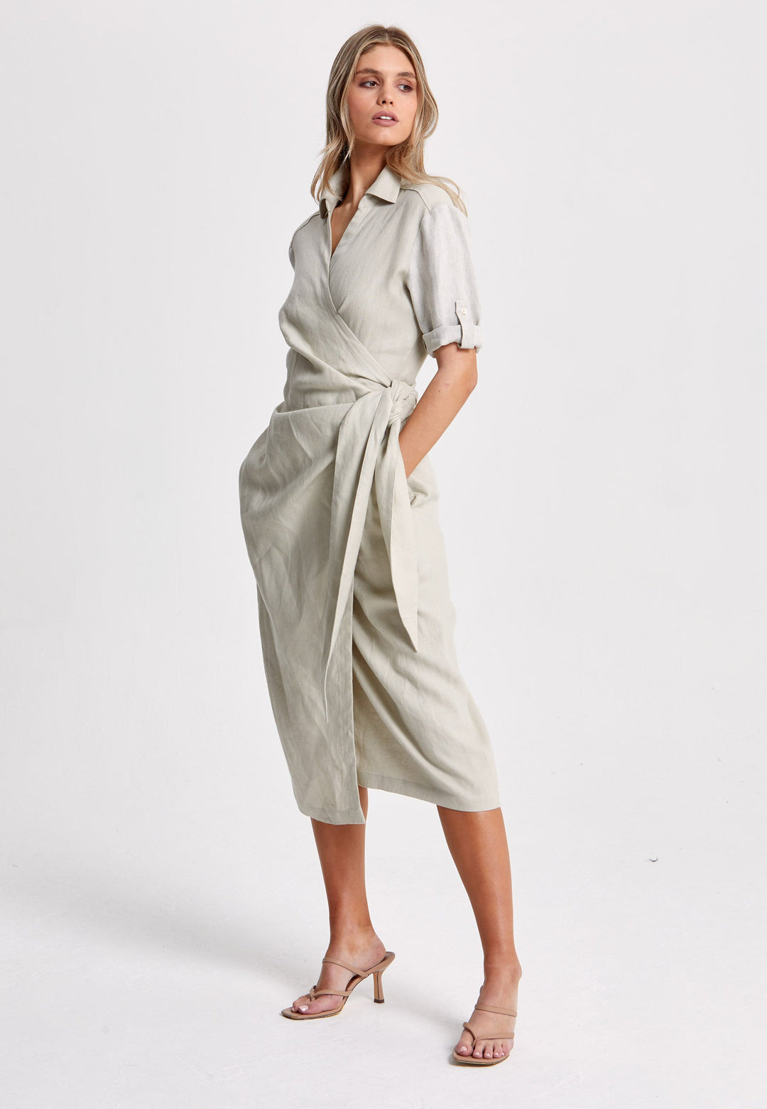 Leonne, the investment-worthy oatmeal linen wrap dress. Crafted in a sustainable Irish linen. An aunthetic wrap dress that ties to the side with a generous belt and flattering gathers at the waist. Engineered with a turned back elbow length sleeve. The ultimate summer staple.