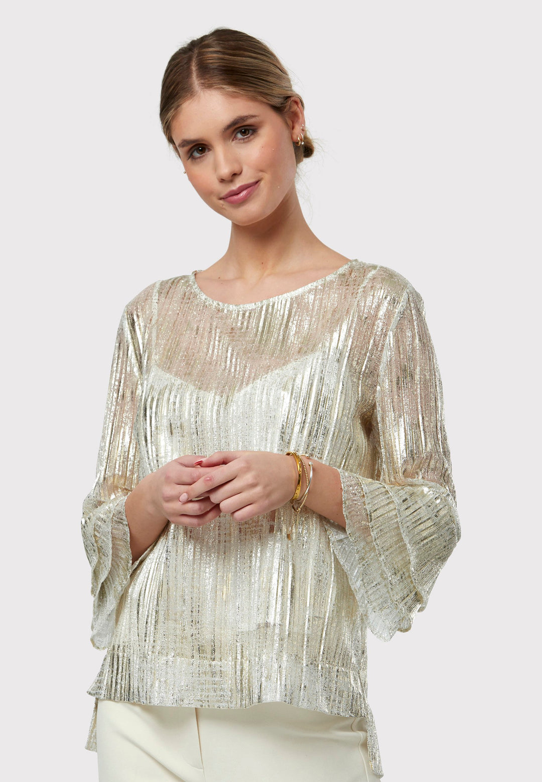 Elevate your evening look with the Lola Golden Blouse. Exuding effortless elegance, this piece boasts an easy fit complemented by a jewel neckline and triple-frilled sleeves. Crafted from luxurious metallic fabric with a semi-transparent allure, it comes complete with a detachable slip, encapsulating the essence of chic sophistication.
