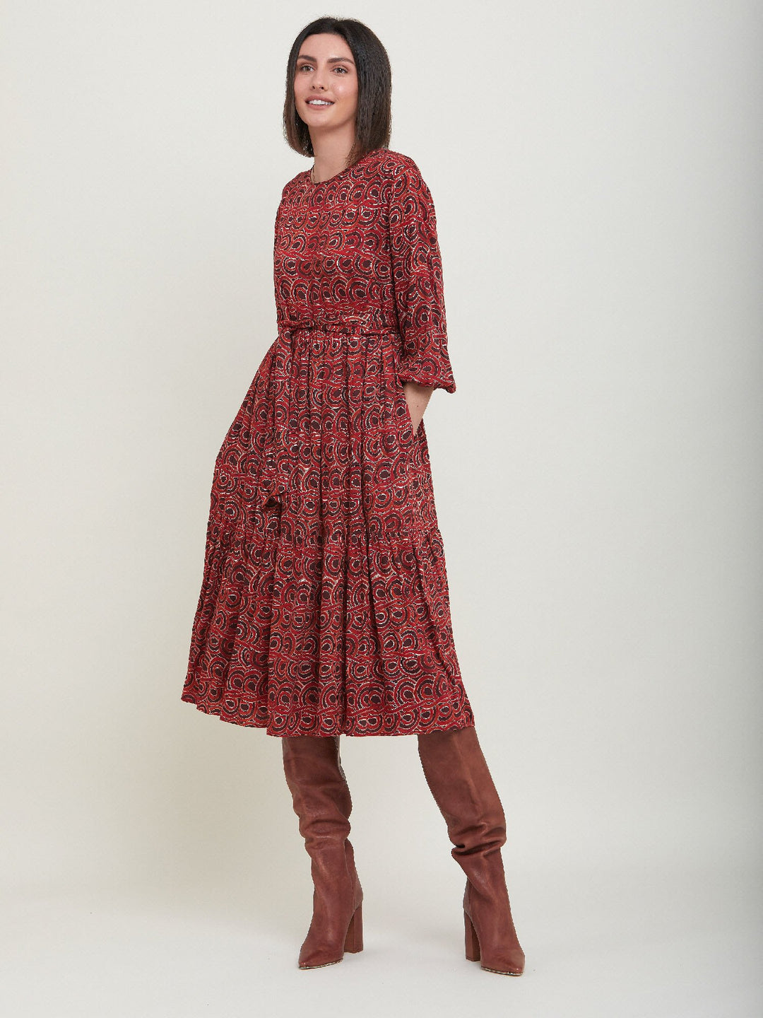 Louis, an easy smock dress. Crafted in a fluid, red & russet tone, abstract print viscose. An empire line dress with handy pockets & a softly gathered two-tier skirt that falls to the mid-calf. Offers a delicate keyhole back neck & a matching belt. Style with a tan boot for a 70's vibe.