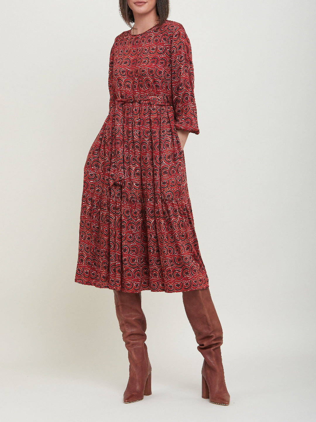 Louis, an easy smock dress. Crafted in a fluid, red & russet tone, abstract print viscose. An empire line dress with handy pockets & a softly gathered two-tier skirt that falls to the mid-calf. Offers a delicate keyhole back neck & a matching belt. Style with a tan boot for a 70's vibe.