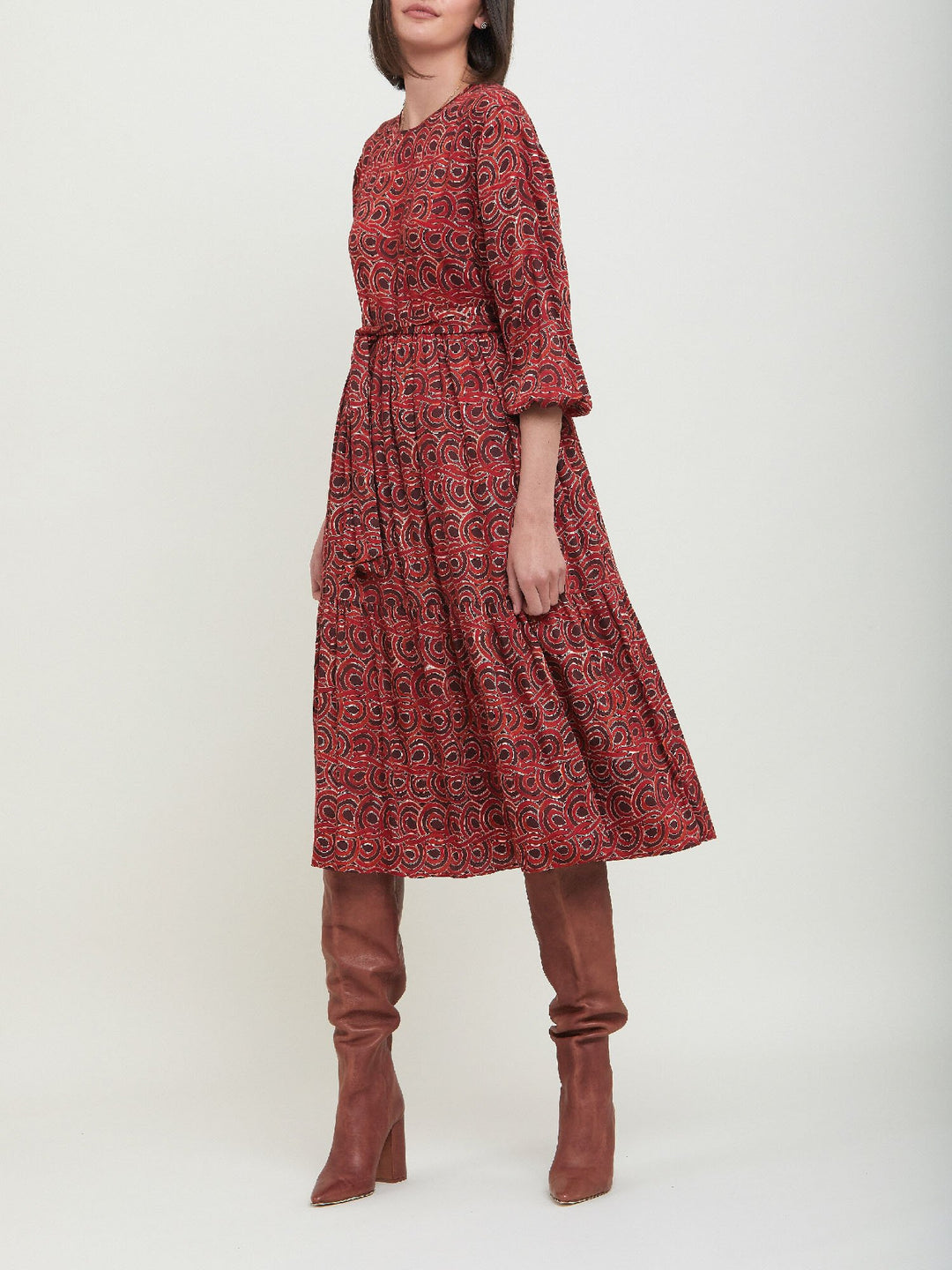 Louis, an easy smock dress. Crafted in a fluid, red & russet tone, abstract print viscose. An empire line dress with handy pockets & a softly gathered two-tier skirt that falls to the mid-calf. Offers a delicate keyhole back neck & a matching belt. Style with a tan boot for a 70's vibe.