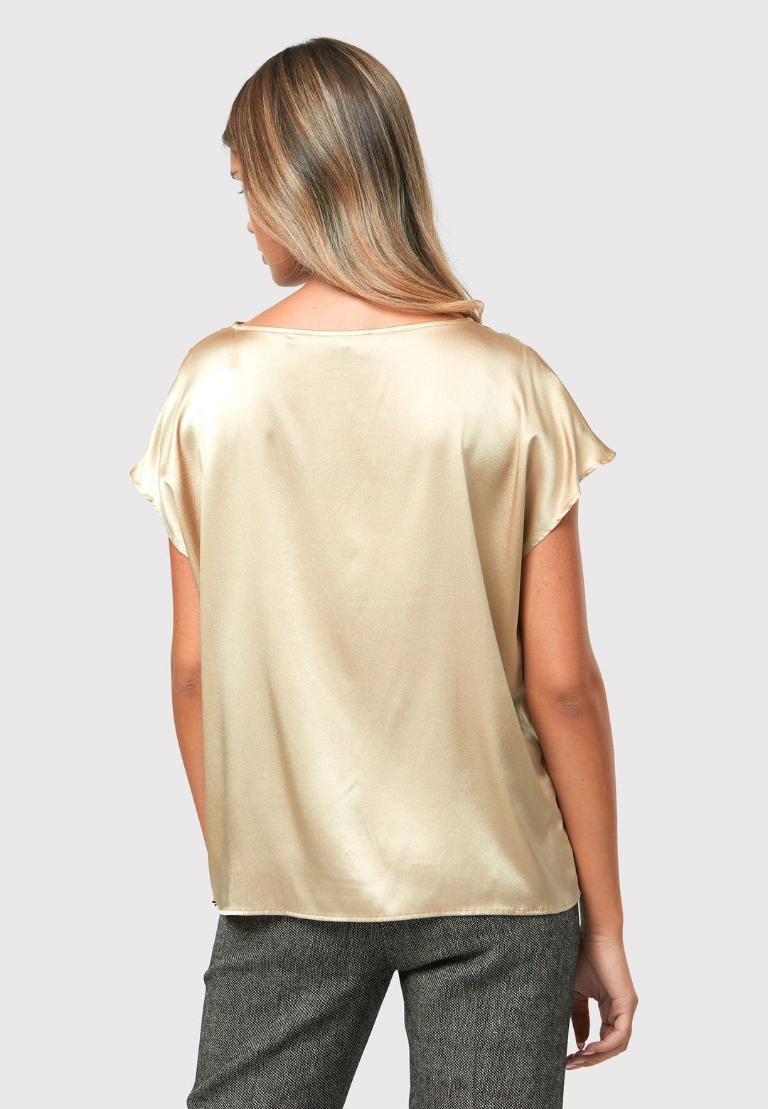 Lucy gold shell top, a luxurious and versatile addition to your wardrobe. Crafted from a lux silk blend, this exquisite top offers a sumptuous feel against your skin.