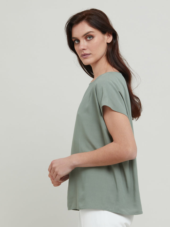 Lucy, our classic shell top redefined in a soft lichen green viscose crepe. A simple wardrobe essential.