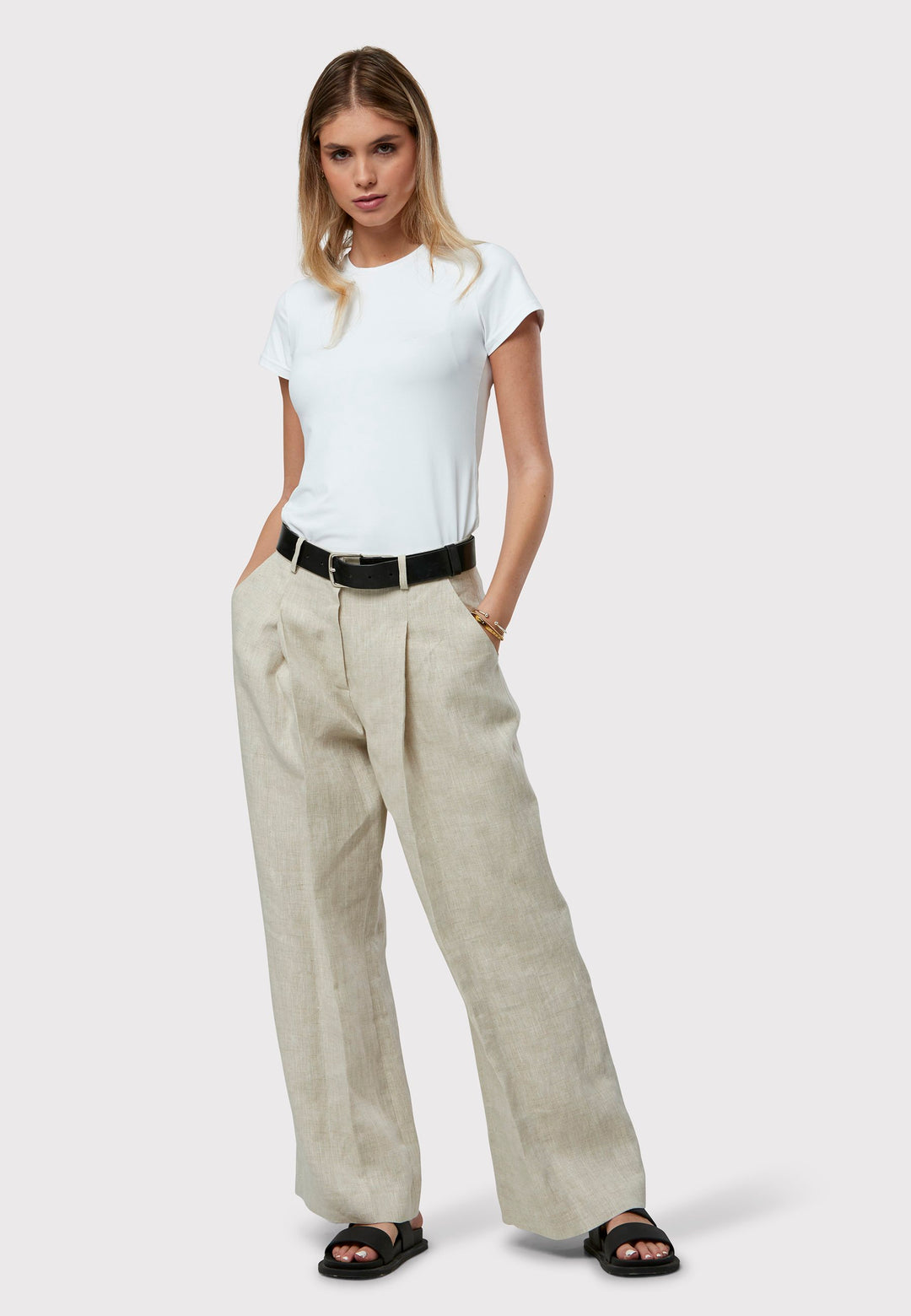 Meet the Lyra Oatmeal Linen Trousers, a stylish and relaxed choice for your wardrobe. With a wide-leg design and pleat front, they blend comfort with sophistication. Made from quality oatmeal linen, these versatile trousers can be dressed up or down for any occasion. Pair with a simple top and casual shoes for a chic, contemporary look that stands out.