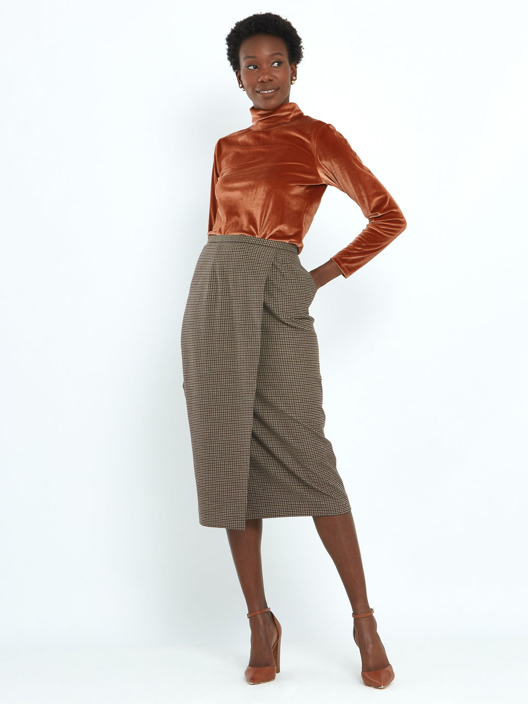 A faux wrap, mid calf length pencil skirt in a soft handle micro check. Sophisticated city style with a hint of heritage. 
